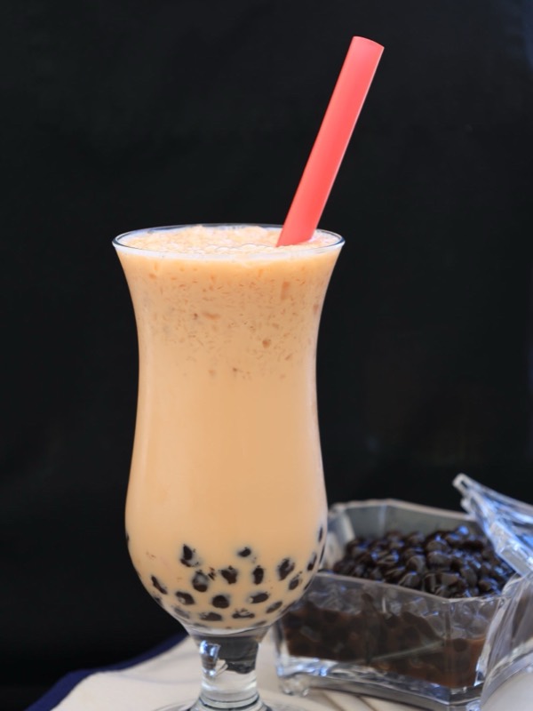 A tall glass of milk tea with pearls