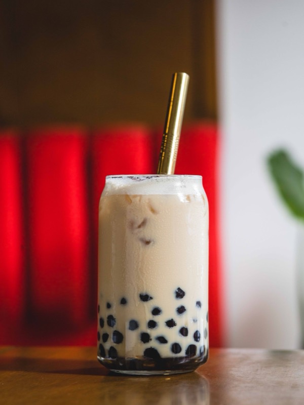 A cold milk tea with pearls on a café table
