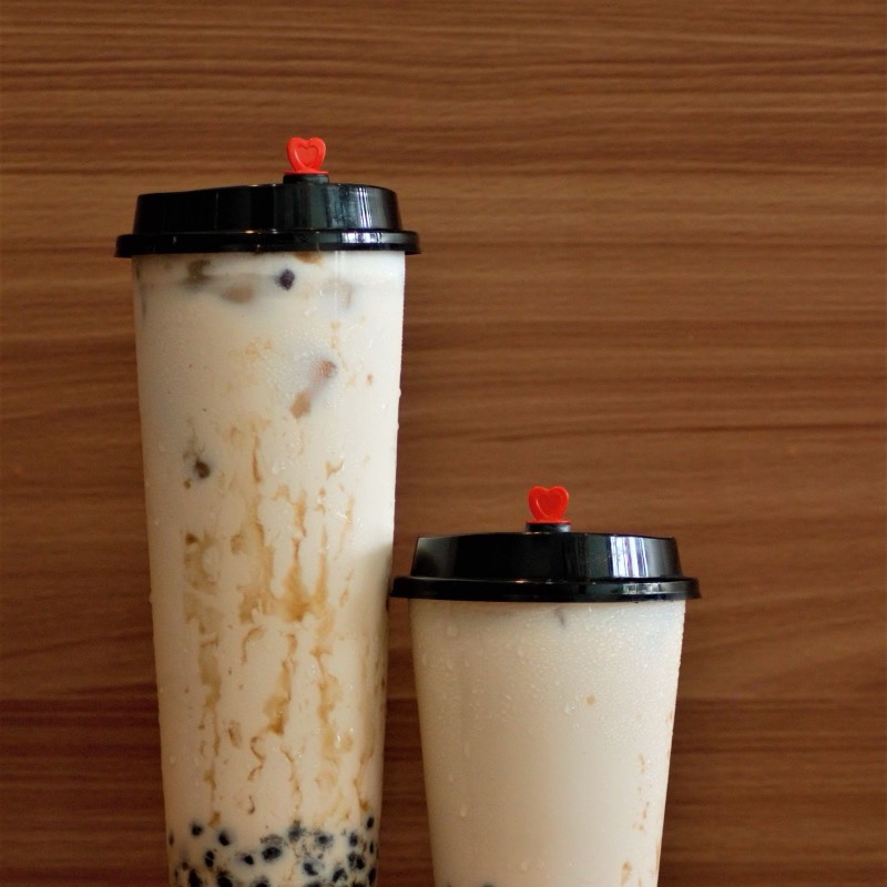 Two cups of milk tea with black tapioca pearls